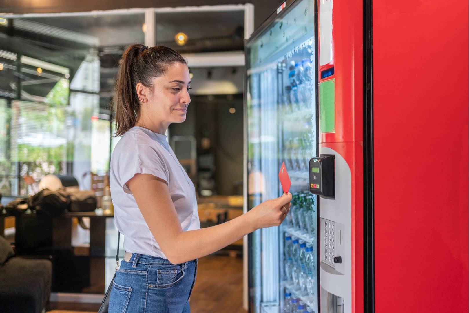 Upward Arrow Photos - 31 Woman at vending machine choosing a bottle of water based on the brand from many similar items.